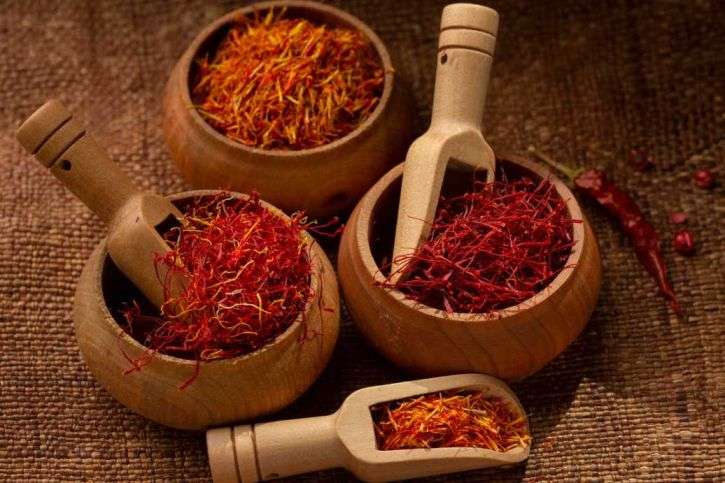 Greek Saffron (Picture showing different types of saffron in various wooden bowls)